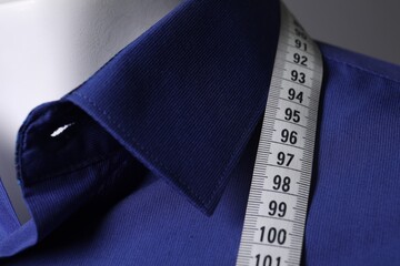 Canvas Print - Mannequin with blue shirt and measuring tape, closeup