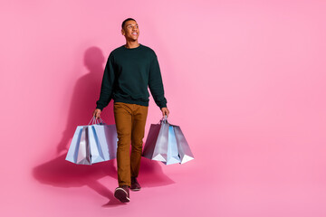 Wall Mural - Full length photo of cheerful positive guy dressed pullover rising bargains looking emtpy space isolated pink color background