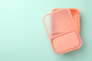 Canvas Print - One empty lunch box on light blue background, top view. Space for text