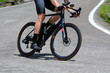 © ChiccoDodiFC - cyclist is pedaling downhill on a smooth asphalt road during a challenging mountain bike competition