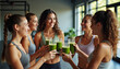 © 2April - Happy Fitness Women Toasting with Green Smoothies in Gym