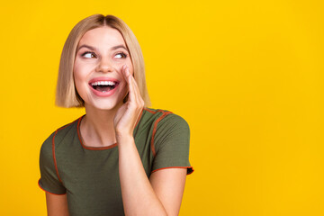 Poster - Photo of good mood girl with bob hairstyle dressed khaki t-shirt look empty space palm on cheek isolated on yellow color background