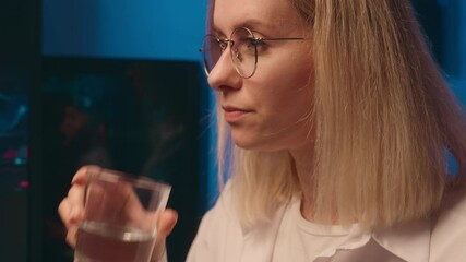 Female hacker crypto trader developer Caucasian woman girl drink water IT programmer bitcoin trading graph code hack computer screen late night home work business investment cryptocurrency e-commerce