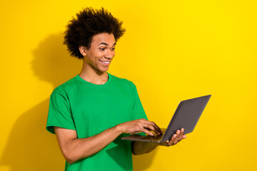 Wall Mural - Photo of funky cool guy dressed green t-shirt texting apple samsung modern gadget emtpy space isolated yellow color background