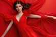 © Anjali - Fashionable young woman in red dress poses for clothing ad.