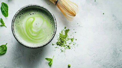 Poster -   Green liquid in a cup on a table with a whisk nearby