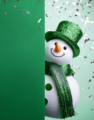 A cute 3D snowman looking sideways .an empty green wall for text space, wearing a red scarf and hat with shiny silver confetti on a green background