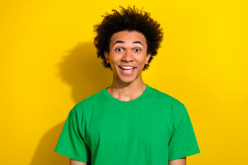 Canvas Print - Photo of excited handsome guy wear green t-shirt open mouth emtpy space isolated yellow color background