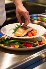 male chef in a professional kitchen making an elaborated dish. restaurant kitchen close-up detailed artwork