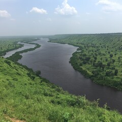 Breathtaking View of Winding River Through Lush Green Landscape Under Clear Blue Sky Perfect for Nature Enthusiasts and Travelers