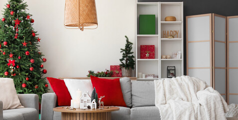 Sticker - Interior of living room with sofas, Christmas trees and candle holders