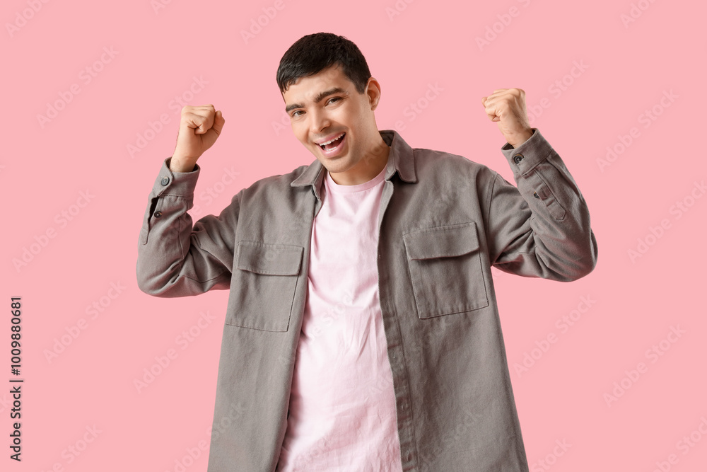 Happy young man on pink background