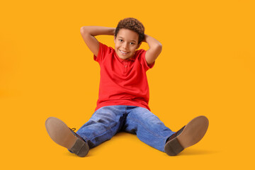 Canvas Print - Little African-American boy on yellow background