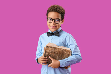 Sticker - Little African-American boy with old book on purple background