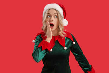 Poster - Shocked young woman dressed as elf on red background