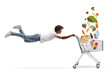 © Ljupco Smokovski - African american guy flying and holding a shopping cart with groceries falling inside