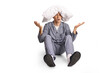 © Ljupco Smokovski - Confused young man in pajamas sitting on the ground with pillow on his head