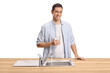 © Ljupco Smokovski - Young man holding a glass of water behind a kitchen sink