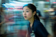 © wolfhound911 - A young Asian nurse intensely focused on her tasks while coordinating with a team in an emergency room. The energy is high, with blurred motion capturing the frantic pace of life-saving interventions
