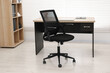© New Africa - Black chair, laptop and desk in office