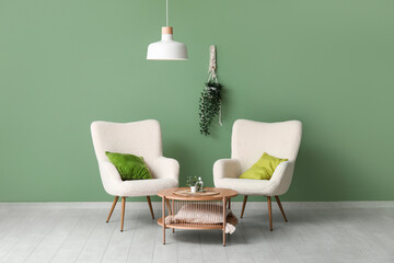 Poster - Stylish living room with white armchairs, coffee table and white hanging lamp