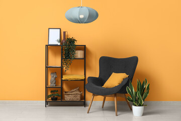 Wall Mural - Stylish living room with black armchair, shelving unit, houseplant and hanging lamp