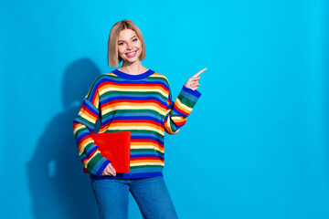 Poster - Photo portrait of lovely young lady point empty space netbook dressed stylish striped garment isolated on blue color background