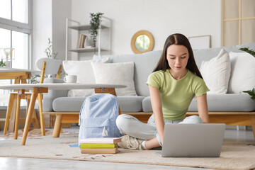 Sticker - Female student studying with laptop on floor at home