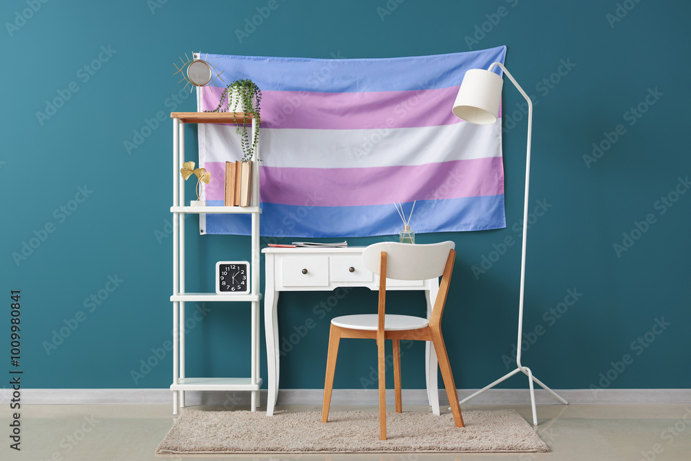Interior of room with table, shelf unit and transgender flag