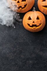 Poster - spooky jack-o-lanterns with smoke on dark background