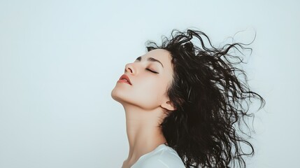 Canvas Print - Young woman with long dark hair against a light background.