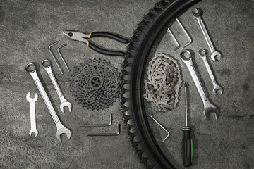 Poster - Parts of bicycle and tools on grey table, flat lay