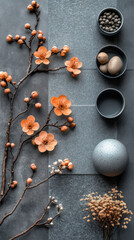 Wall Mural - Peach blossoms and dried flowers on a grey background.