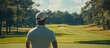 © BloomArt - Golfer Looking at the Green with a White Cap