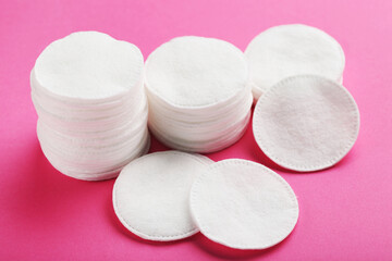 Soft cotton pads on pink background