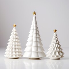 three Christmas white porcelain fir trees with a gold star on the top of their heads of different sizes on a white background. Scandinavian style 