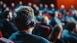 © Ariestia - A young man wearing Hearing Aids in a crowded room