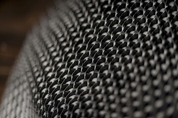 Close-up of a textured black and white surface with a repeating hexagonal pattern