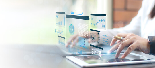 Businesswoman using computer for development and Analytics Data technology management System for report marketing strategy planning. graph analysis and information on a futuristic virtual screen.