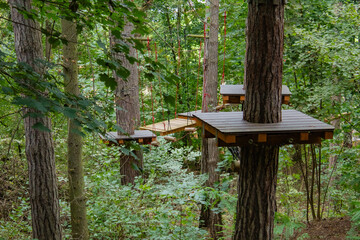 obstacles for children and adults, rope park, in the middle of the forest in autumn