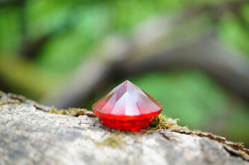 A red decorative glass ruby. A precious stone.