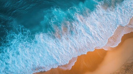 Ocean waves rolling onto a Vietnam beach, seen from above in a stunning aerial view, with blue water and soft sand creating a tranquil summer scene.