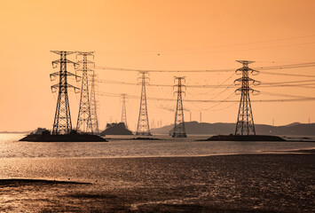 Wall Mural - Power cables of transmission towers on the sea with the background of Yeongheung Thermal Power Plant at Yeongheungdo Island near Ongjin-gun, Incheon, Korea