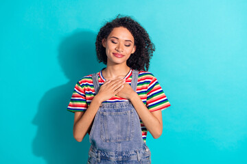 Wall Mural - Photo of positive smiling lady put hands chest feel gratitude isolated cyan color background