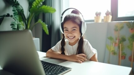 A cheerful young girl with headphones smiles while engaged in an online class, surrounded by greenery and light.