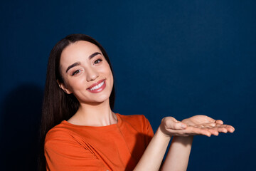 Sticker - Photo of lovely adorable nice woman wear orange stylish clothes hold empty space isolated on dark blue color background