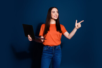 Poster - Photo of charming pretty woman wear orange stylish clothes demonstrate empty space isolated on dark blue color background