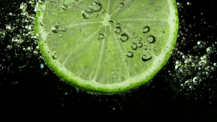 Fototapete - Macro Shot of a Lime Slice in Water with Air Bubbles