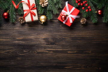 Wall Mural - Christmas presents and holiday decorations on wooden background. Flat lay image.