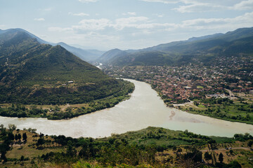 spectacular view of the confluence of two rivers surrounded by mountains in a vibrant valley during 